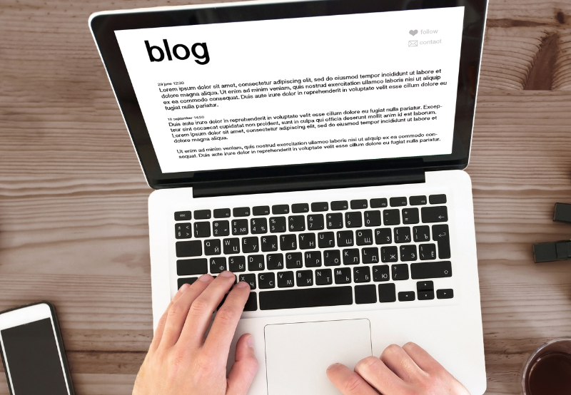 typing a dental blog on laptop